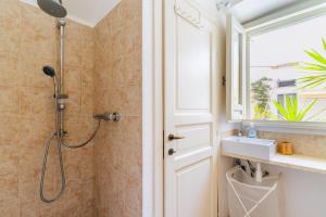 a bathroom with a shower and a sink and a window at L'angolo Fiorito in Ugento +40 photos