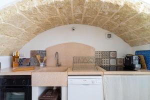 a kitchen with a sink and a counter top at L'angolo Fiorito in Ugento