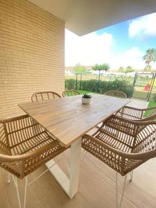 a wooden table with rattan chairs and a tableasteryasteryasteryasteryasteryastery at Casa Roberto - Golf y relax in San Jorge