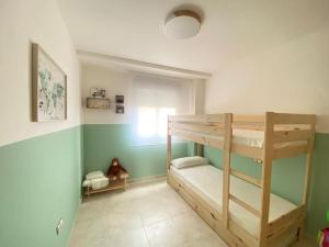 a room with two bunk beds and a window at Casa Roberto - Golf y relax in San Jorge +9 photos