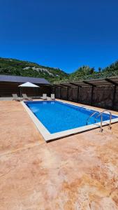 a large swimming pool sitting on top of a patio at Vinogradina Eco Vukčević in Virpazar