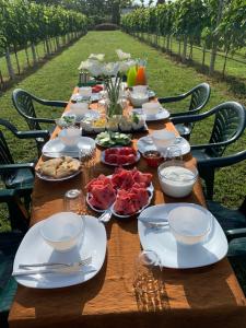 a long wooden table with plates of food on it at Hotel Villa Linda in Shkodër