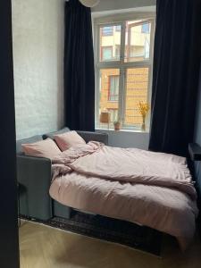 a bed in a room with a window at Attraktiv og klassisk leilighet midt i Oslo, 80m2 in Oslo
