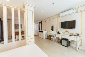 a bedroom with a bed and a tv on a wall at Tuyet Son Hotel (TS Ocean Hotel) in Da Nang
