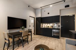 uma cozinha e sala de jantar com uma mesa preta e cadeiras em The APARTMENTS Company- Frogner em Oslo