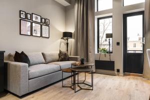 a living room with a couch and a table at The APARTMENTS Company- Frogner in Oslo