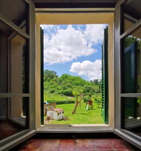 ein offenes Fenster mit Blick auf einen Hof in der Unterkunft Molino del prato in Volterra