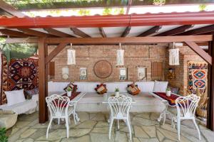 a patio with a couch and chairs and a table at Akanthus Hotel Ephesus in Selcuk