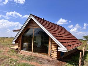 a small cabin with a red roof at Kilimanjaro view cabin-Amboseli in Oloitokitok 