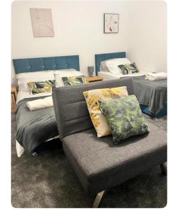a living room with a couch and two beds at The Hideout in Trearddur