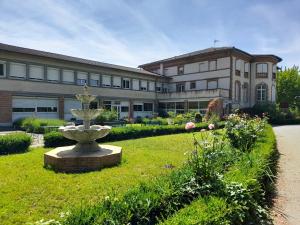 a large building with a fountain in the middle of a yard at Centre Louis Ormières in Montauban