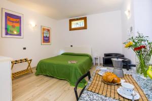 a small room with a bed and a table with a table sidx sidx at Il Borgo Monolocali in Bellagio