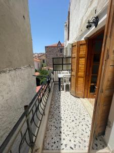 a balcony with benches and a table on a building at The Beehive 2 in Mytilini