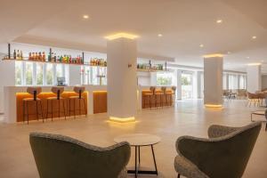 a lobby with chairs and a bar in a building at whala!isabela in Santa Ponsa