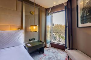 a hotel room with a bed and a window at TURIM Boulevard Hotel in Lisbon