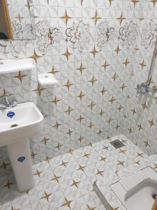 a bathroom with a sink and a toilet at Mashal Palace in Nathia Gali