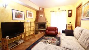 a living room with a couch and a flat screen tv at Heart Of Sicily in Mistretta