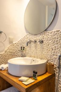 a bathroom with a sink and a mirror at NAMASTE Boutique Apartments Mykonos in Tourlos