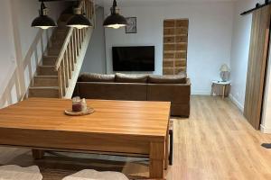 a living room with a couch and a table at Légendes d'automne in LʼHospitalet-près-lʼAndorre