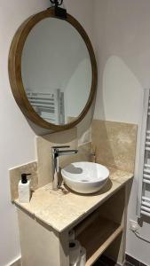 a bathroom with a sink and a mirror on a counter at Légendes d'automne in LʼHospitalet-près-lʼAndorre +13 photos