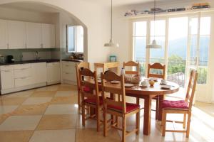 a kitchen with a wooden table and chairs and a table at Villabellevie Bargemon Var in Bargemon