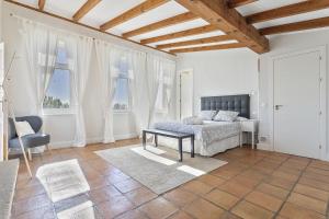 a bedroom with a bed in a room with windows at Casa de lujo con piscina, pádel y BBQ in Candeleda +63 photos