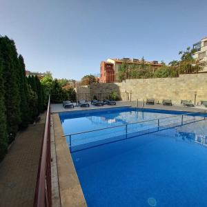 a large swimming pool with blue water at Helios Seaview Apartment in Sveti Vlas