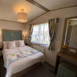 a bedroom with a bed and a window at David's place at Tattershall lakes in Tattershall