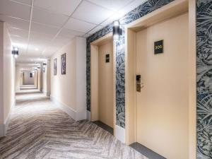 a corridor of a hospital hallway with a corridoraceuticalaceuticalaceuticalaceuticalaceuticalaceutical companies at ibis Styles Hotel Brussels Centre Stéphanie in Brussels