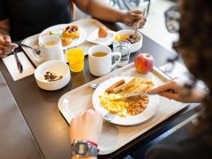 a table with a plate of breakfast food on it at ibis Styles Hotel Brussels Centre Stéphanie in Brussels