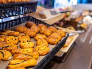 a bunch of pastries on display in a bakery at ibis Styles Hotel Brussels Centre Stéphanie in Brussels