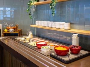 a buffet line with different types of food on it at ibis Styles Hotel Brussels Centre Stéphanie in Brussels