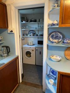 a kitchen with blue and white dishes on shelves at Halcyon Days in Kenwyn
