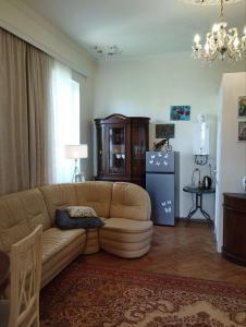 a living room with a couch and a refrigerator at Barateli in Kʼutʼaisi