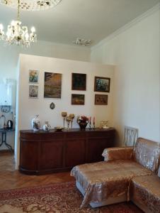 a living room with a couch and a table at Barateli in Kʼutʼaisi
