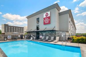 a pool in front of a hotel next to a building at Best Western Plus Greenville I-385 Inn & Suites in Greenville