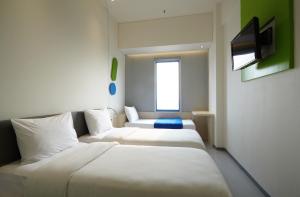Postel nebo postele na pokoji v ubytování POP! Hotel Festival Citylink