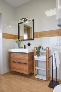 a bathroom with a sink and a mirror at Szczęśliwe Siedlisko in Rumy +57 photos