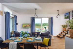 a living room with a table and chairs at Szczęśliwe Siedlisko in Rumy