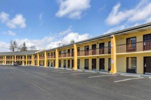 a large yellow building with a parking lot at Quality Inn Hillsville in Hillsville