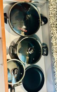 a bunch of pots and pans in a drawer at Centaurus Apartment Three Bed in Islamabad