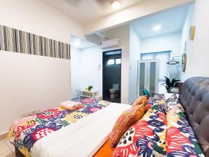 a bedroom with a large bed with colorful blankets at AZ Suites 1 @Putrajaya Cyberjaya in Cyberjaya +39 photos