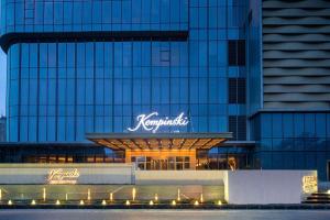 a large building with a sign on top of it at Kempinski Hotel Nanjing in Nanjing