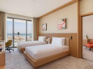 Ένα ή περισσότερα κρεβάτια σε δωμάτιο στο Rixos Premium Qetaifan Island North