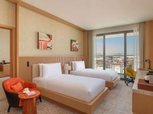 Ένα ή περισσότερα κρεβάτια σε δωμάτιο στο Rixos Premium Qetaifan Island North