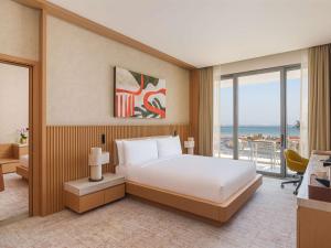 Ένα ή περισσότερα κρεβάτια σε δωμάτιο στο Rixos Premium Qetaifan Island North
