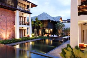 an external view of a villa with a swimming pool at U Chiang Mai in Chiang Mai