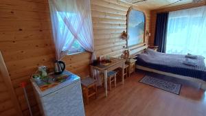 a bedroom with a bed and a table in a room at Садиба Гуцулка Ксеня in Yaremche