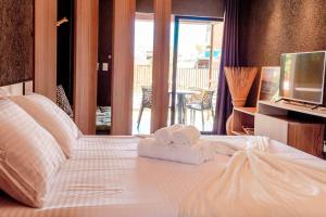 - une chambre avec des serviettes sur un lit et un balcon dans l'établissement Apto 001 B GAMBOA, à Porto de Pedras