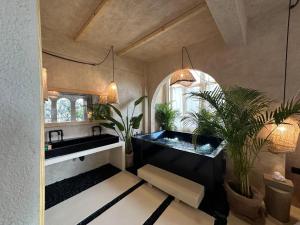 a bathroom with a bathtub with plants in it at Biophilia Luxury Lofts in Beirut